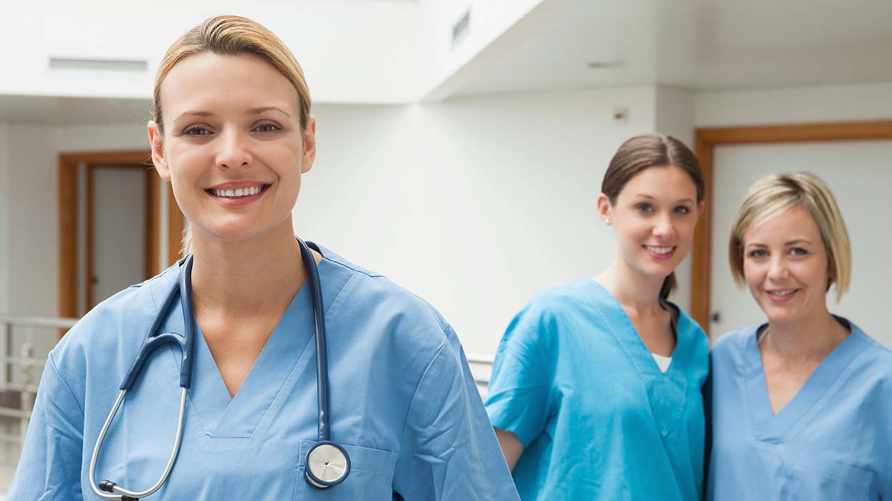 staff at the clinic stops to smile for a phot