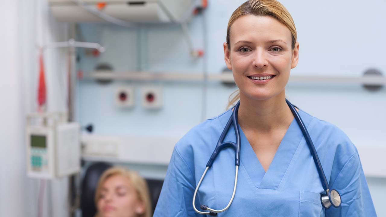 PA in blue scrubs smiling at the top weight loss clinic