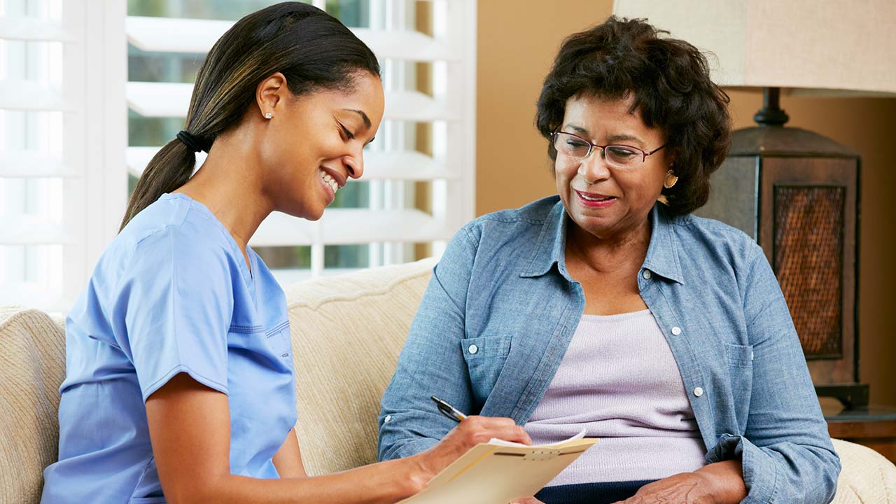 physician assistant talking with a client and reviewing their medical history